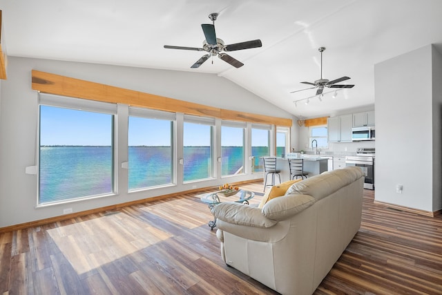 living room with visible vents, baseboards, a water view, lofted ceiling, and dark wood-style floors