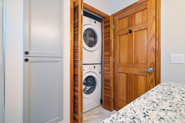 10701 S Ocean Dr Unit 876, Jensen Beach, FL 34957 - laundry room with marble finish floor, stacked washer / drying machine, and laundry area
