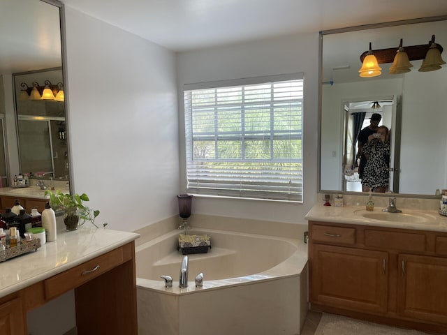 full bathroom featuring vanity, a garden tub, and a stall shower