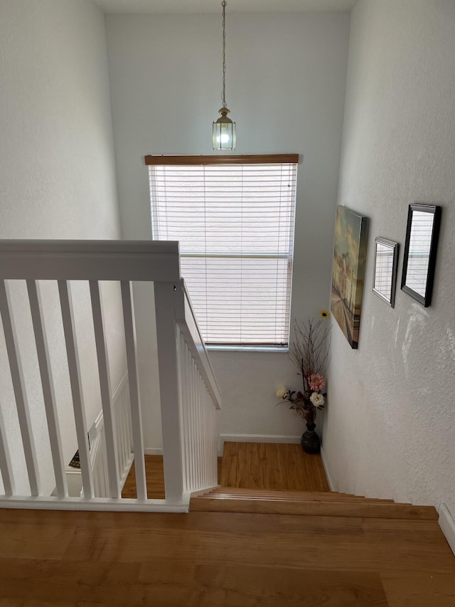 stairway featuring a textured wall