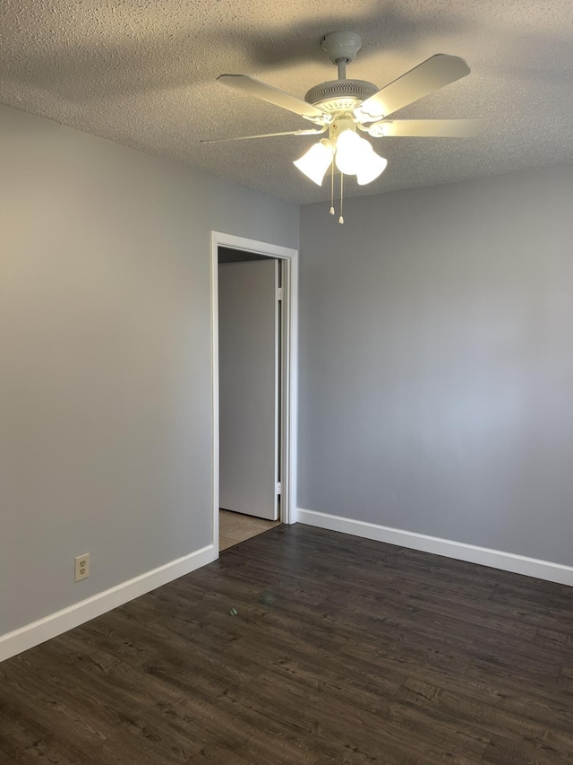 empty room featuring baseboards, a textured ceiling, wood finished floors, and a ceiling fan
