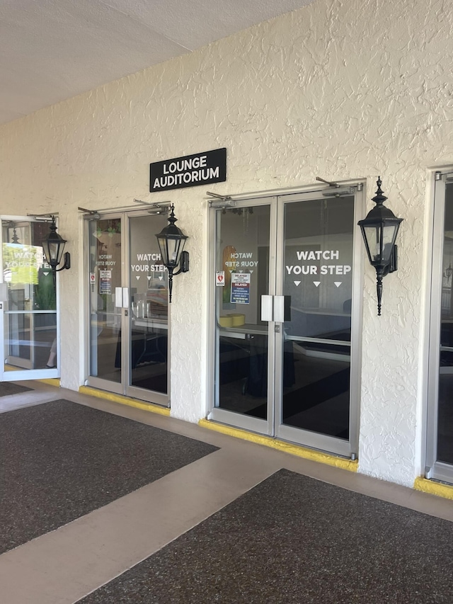 view of exterior entry featuring stucco siding