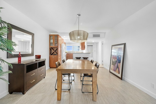 dining space featuring baseboards and visible vents