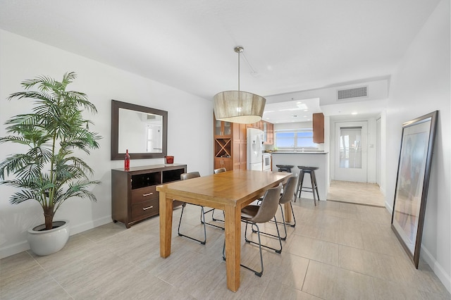 dining space featuring baseboards and visible vents