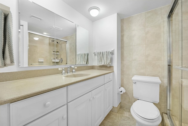 bathroom featuring tile patterned floors, visible vents, tile walls, and a shower stall