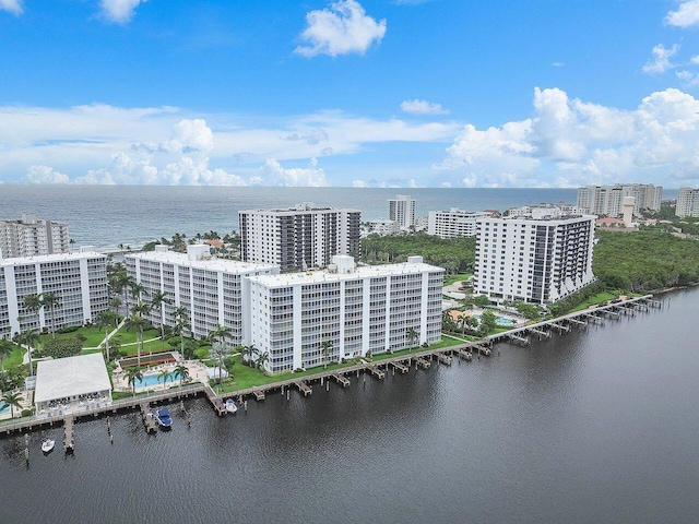 birds eye view of property with a water view and a city view