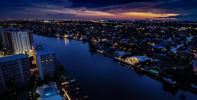 birds eye view of property featuring a city view and a water view