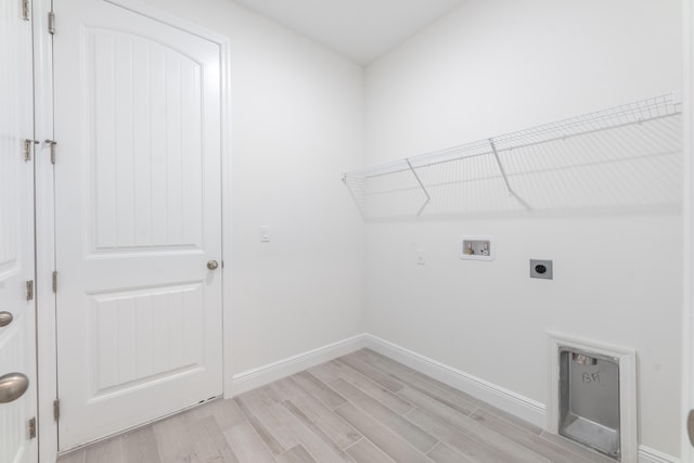 clothes washing area with hookup for a washing machine, baseboards, laundry area, light wood-style flooring, and electric dryer hookup