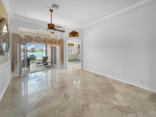 empty room featuring baseboards, arched walkways, ceiling fan, crown molding, and marble finish floor