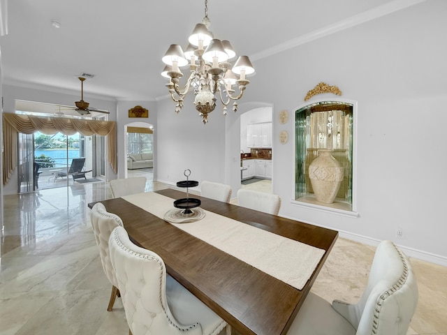 dining area with baseboards, arched walkways, ornamental molding, ceiling fan with notable chandelier, and marble finish floor