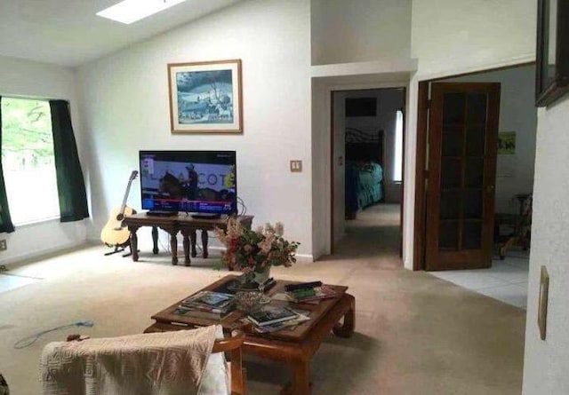 living area featuring vaulted ceiling and light carpet