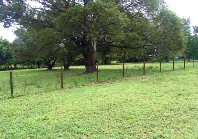 view of yard featuring a rural view and fence