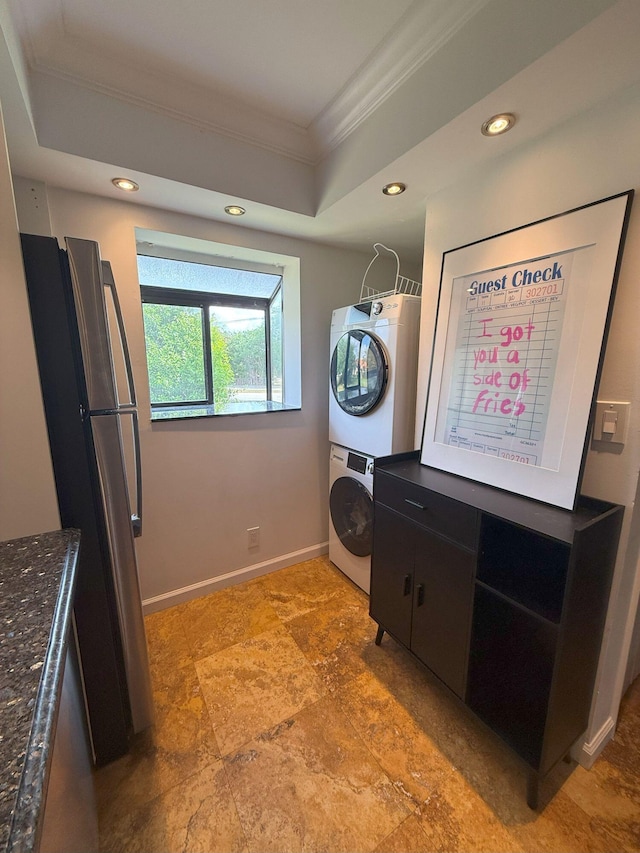 laundry area with baseboards, stacked washing maching and dryer, laundry area, recessed lighting, and ornamental molding