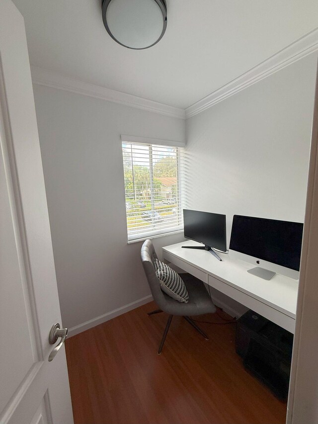 office with baseboards, wood finished floors, and ornamental molding