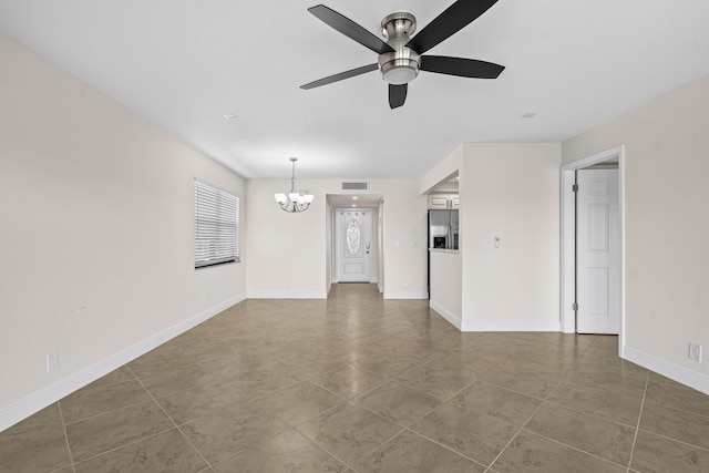 unfurnished living room with visible vents, baseboards, and ceiling fan with notable chandelier