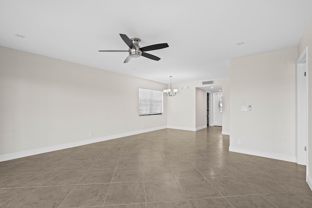 unfurnished room featuring visible vents, ceiling fan with notable chandelier, and baseboards