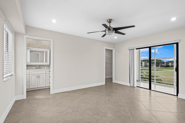 unfurnished bedroom featuring a walk in closet, recessed lighting, and baseboards