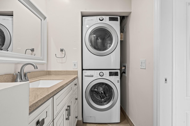 washroom with stacked washer and dryer and a sink