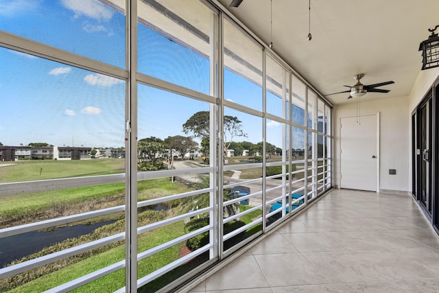 unfurnished sunroom with a ceiling fan