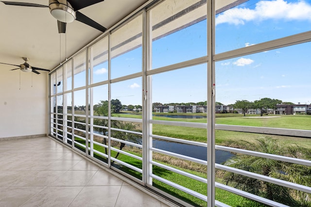 unfurnished sunroom with ceiling fan