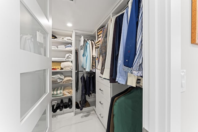 walk in closet with marble finish floor