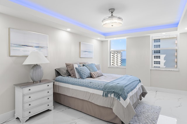 bedroom with a raised ceiling, recessed lighting, baseboards, and marble finish floor