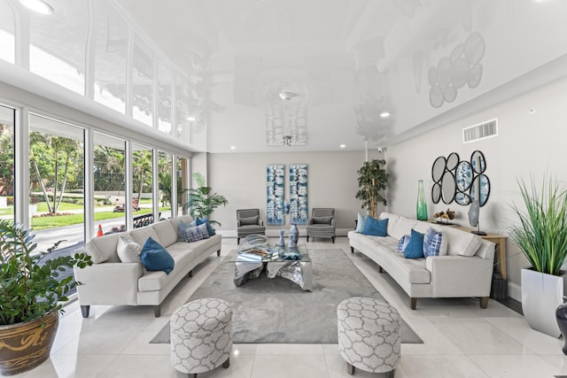 living room featuring light tile patterned floors, recessed lighting, and visible vents