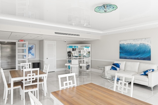 living area featuring light tile patterned floors and baseboards