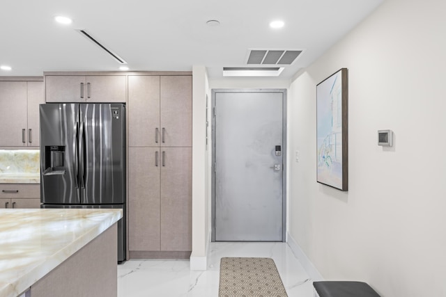 kitchen featuring recessed lighting, visible vents, marble finish floor, and stainless steel fridge with ice dispenser