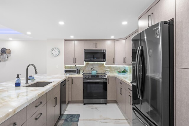 kitchen featuring light stone counters, a sink, stainless steel appliances, marble finish floor, and tasteful backsplash