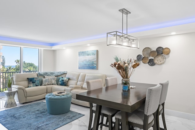 dining area with marble finish floor and baseboards