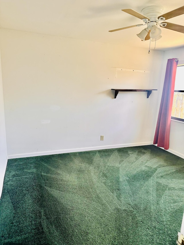 unfurnished room with carpet floors, a ceiling fan, and baseboards