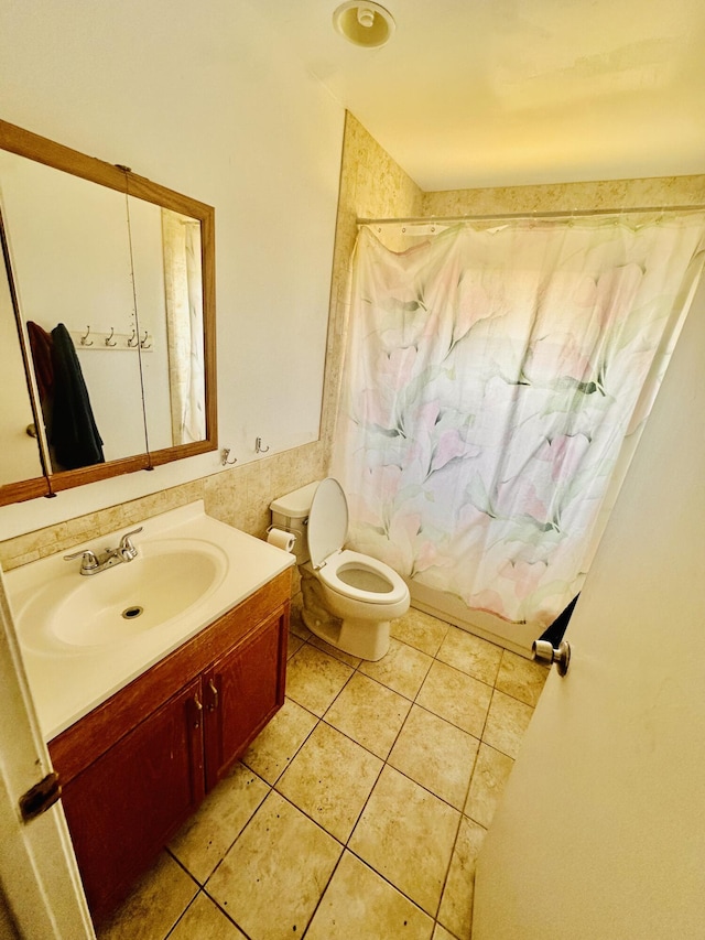 full bath with toilet, tile patterned floors, shower / bath combo, and vanity