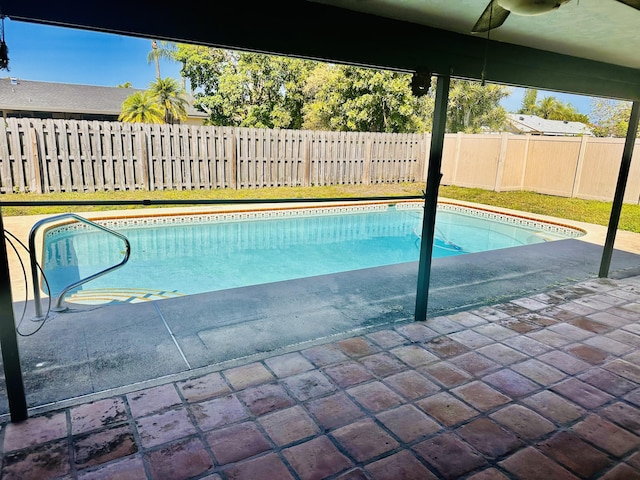 view of pool with a fenced in pool, a ceiling fan, a patio, and a fenced backyard