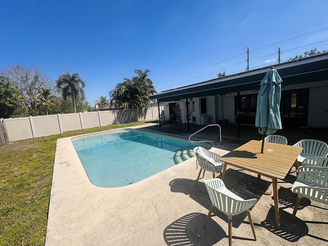 view of swimming pool with a fenced in pool, a fenced backyard, a patio area, and a lawn