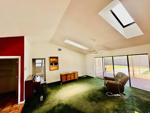 interior space featuring a ceiling fan, visible vents, a healthy amount of sunlight, and vaulted ceiling with skylight