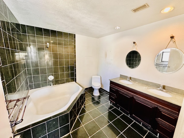 full bath featuring visible vents, a sink, a textured ceiling, tiled bath, and tile patterned flooring