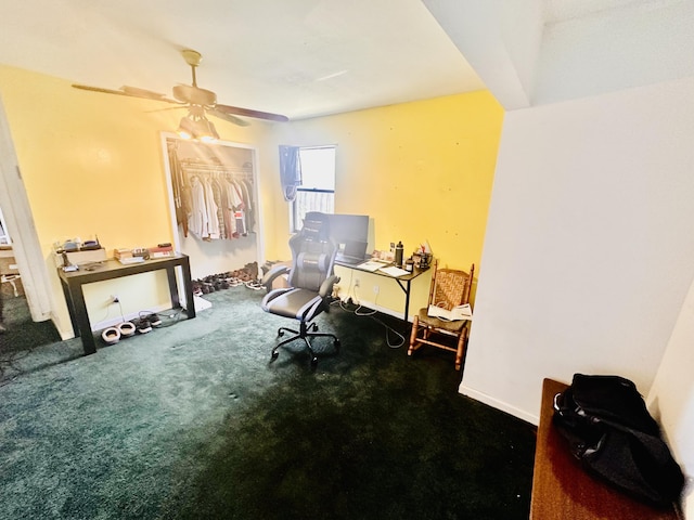 carpeted office space featuring ceiling fan