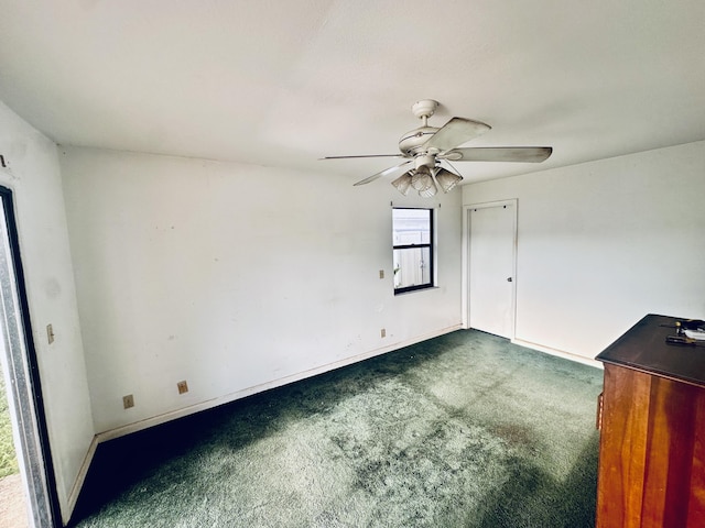 empty room with baseboards, carpet, and a ceiling fan