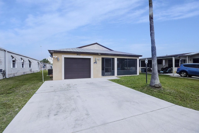 view of front of home with stucco siding, an attached garage, concrete driveway, and a front yard