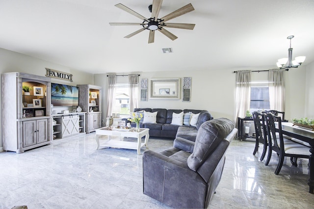 living room featuring ceiling fan with notable chandelier, visible vents, and marble finish floor