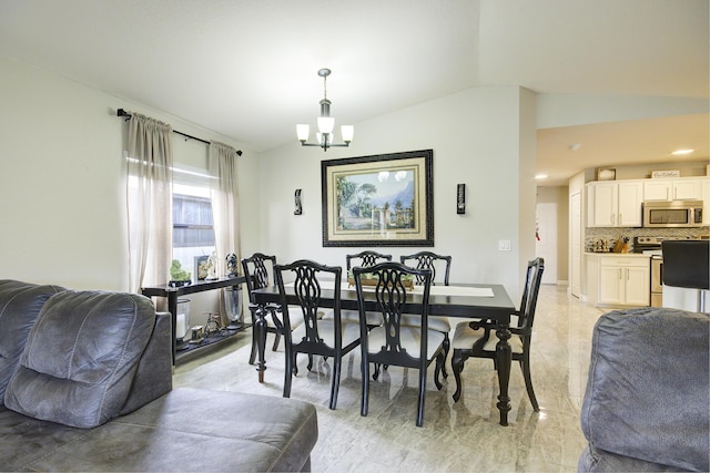 dining area with a notable chandelier and lofted ceiling