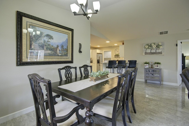 dining space with lofted ceiling, baseboards, visible vents, and a chandelier