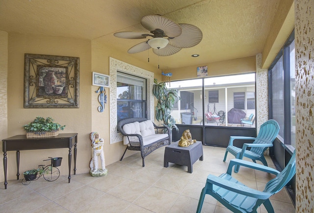 sunroom / solarium featuring a ceiling fan