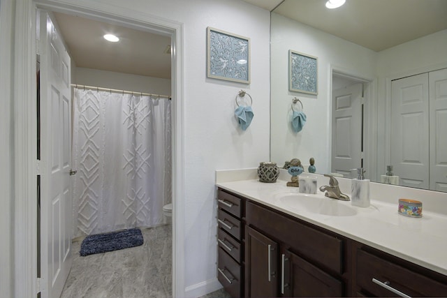 bathroom featuring recessed lighting, toilet, and vanity