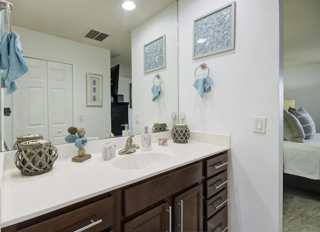 ensuite bathroom featuring vanity, ensuite bath, and visible vents