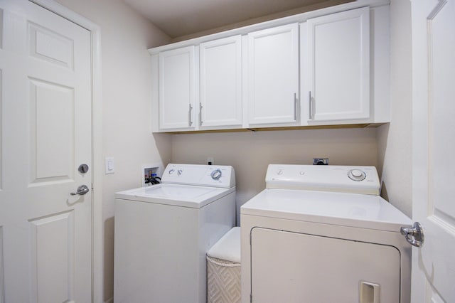 washroom featuring cabinet space and independent washer and dryer