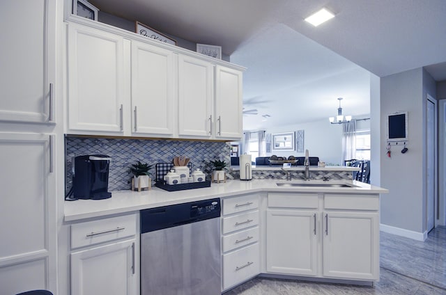 kitchen with dishwasher, decorative backsplash, a peninsula, white cabinets, and a sink