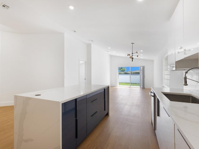 4524 Concordia Ln, Boynton Beach, FL 33436 - kitchen featuring modern cabinets, light wood-style flooring, a spacious island, light stone counters, and recessed lighting