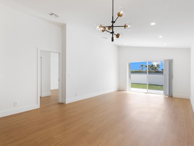 4524 Concordia Ln, Boynton Beach, FL 33436 - empty room featuring a chandelier, recessed lighting, light wood finished floors, and lofted ceiling